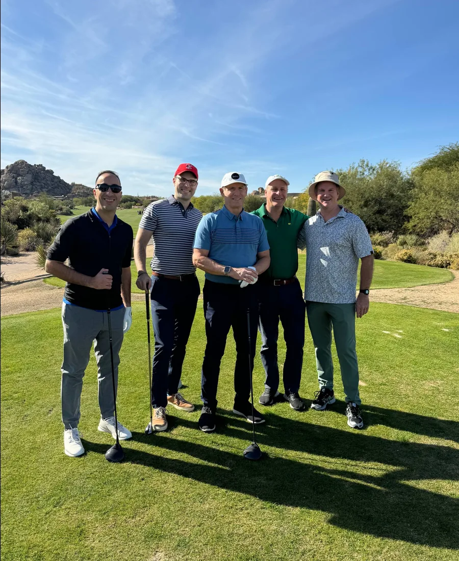 Chris with guests on a golf course