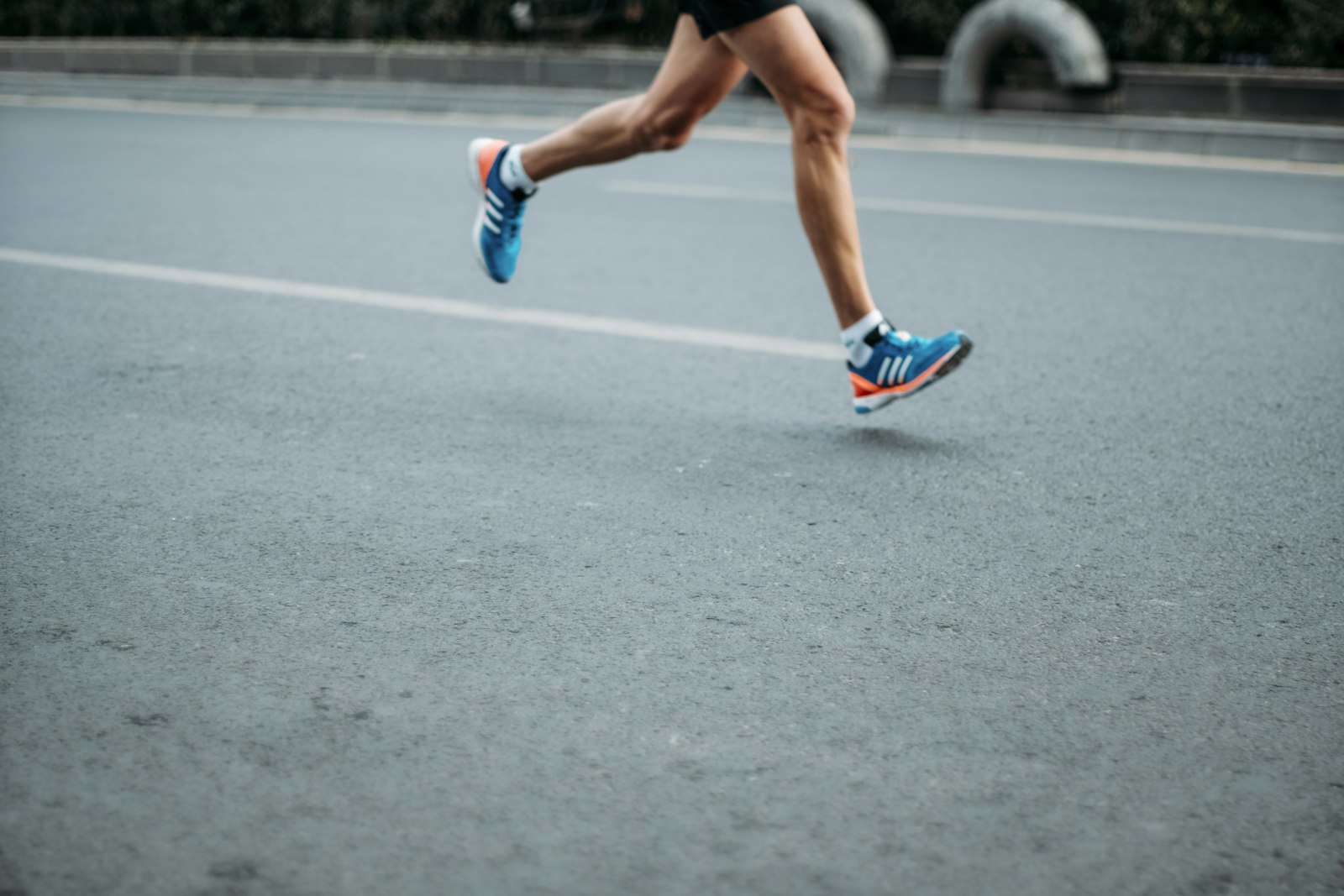Runner mid-stride on race road
