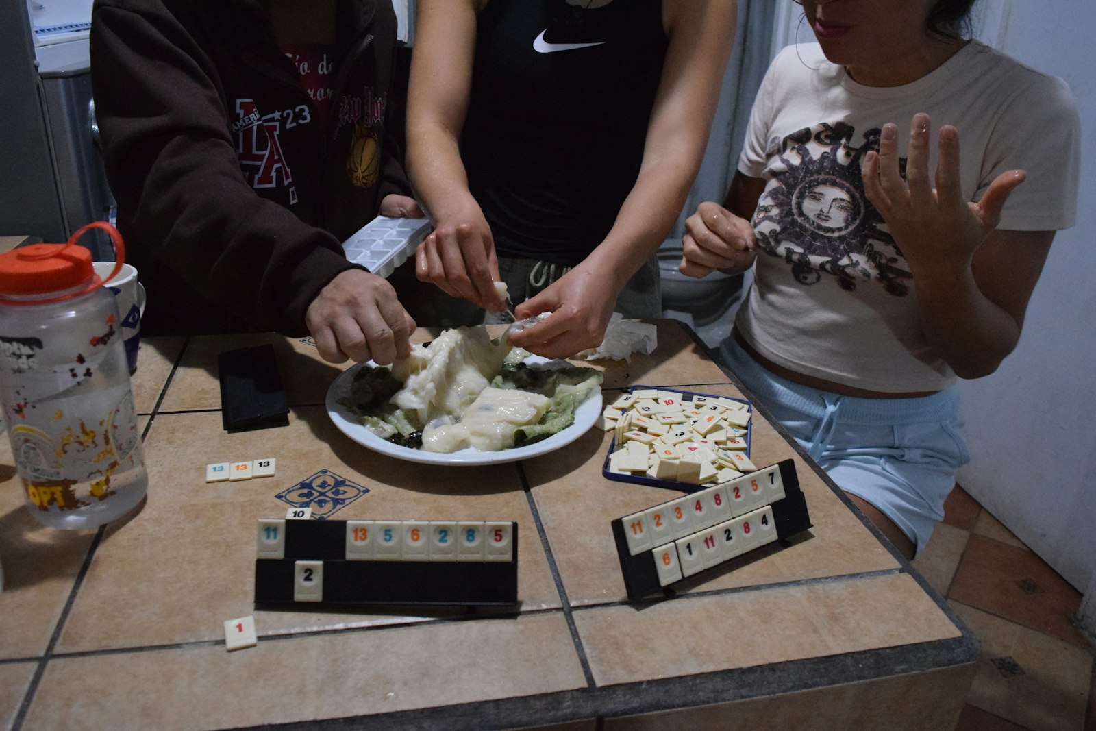 Friends cooking and gathering in a real kitchen